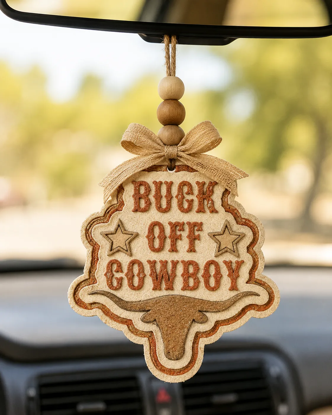 Western Buck Off Cowboy car freshie shaped like a bucking bull rider cowboy, a handmade aroma bead air freshener hanging from a rearview mirror for country and rodeo fans.