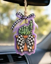 Handmade potted succulent car freshie with a green succulent plant and a trendy black and white checkered bow, a scented aroma bead air freshener for hanging on a car rearview mirror.