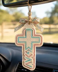 Handmade cross-shaped car freshie air freshener made from scented aroma beads, hanging from a rear view mirror with twine, in a faith-inspired Christian western style.