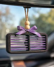 Handmade western country car vent freshie, a scented aroma bead air freshener clipped onto a car AC vent.