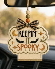 Handmade Keepin' It Spooky Halloween ghost freshie car air freshener made of scented aroma beads hanging from a car rearview mirror.