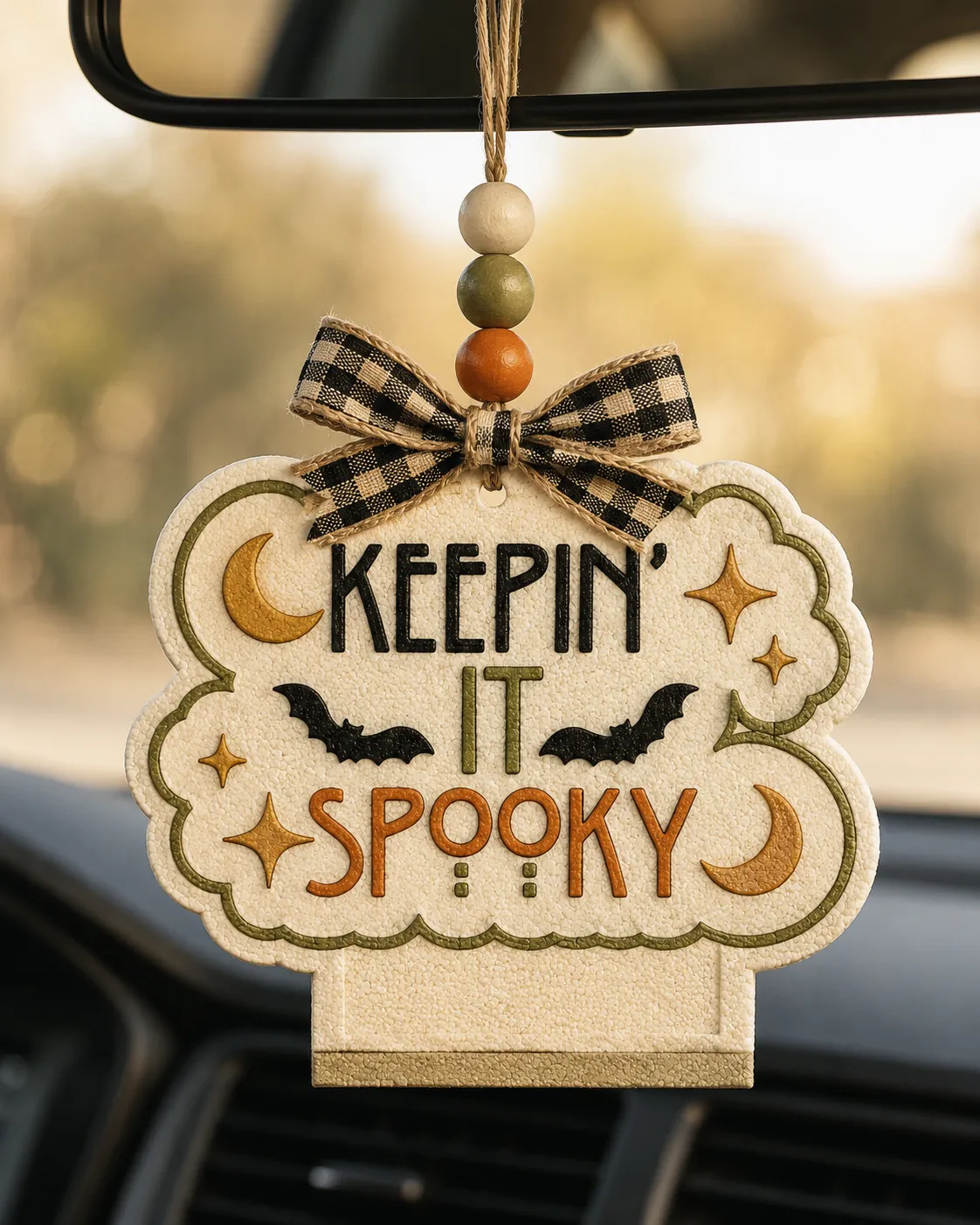 Handmade Keepin' It Spooky Halloween ghost freshie car air freshener made of scented aroma beads hanging from a car rearview mirror.
