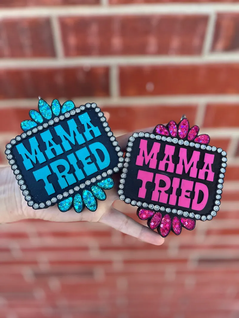 Handmade scented aroma bead car freshie air freshener with bold MAMA TRIED block letters framed by a silver rhinestone border and teardrop gem corners in a western cowgirl bling style.