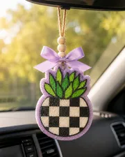 Handmade succulent-shaped car freshie sitting in a black and white checkered pot, a scented aroma bead air freshener with a trendy boho plant design.