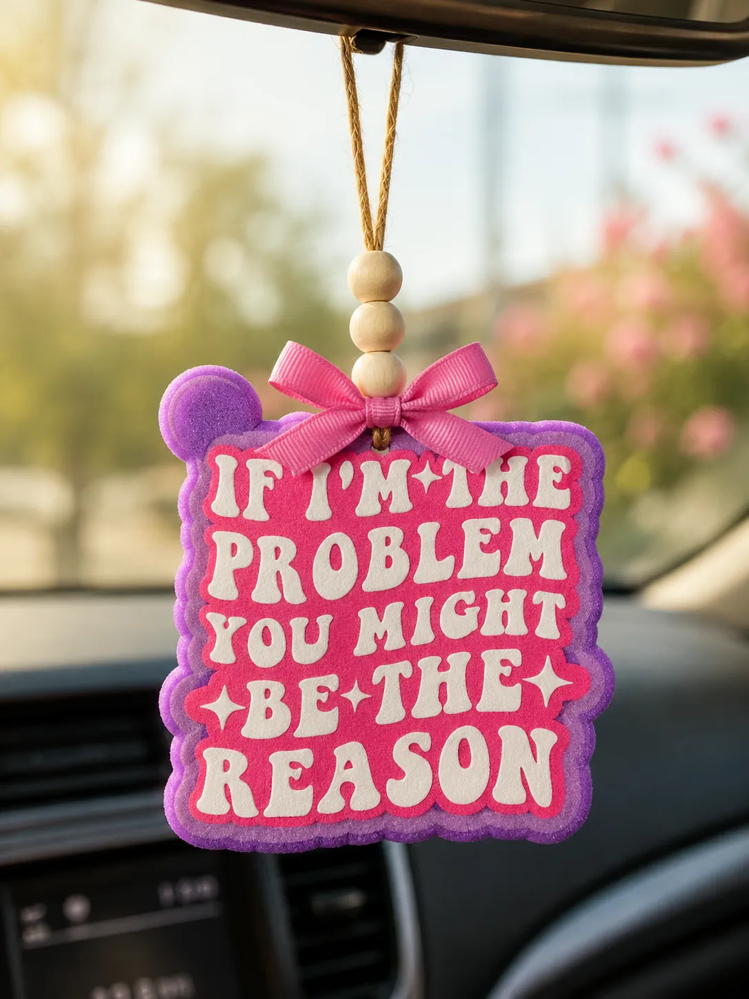 Handmade western-style aroma bead car freshie with bold 'The Problem' text design, hanging from a car rearview mirror as a funny novelty air freshener.
