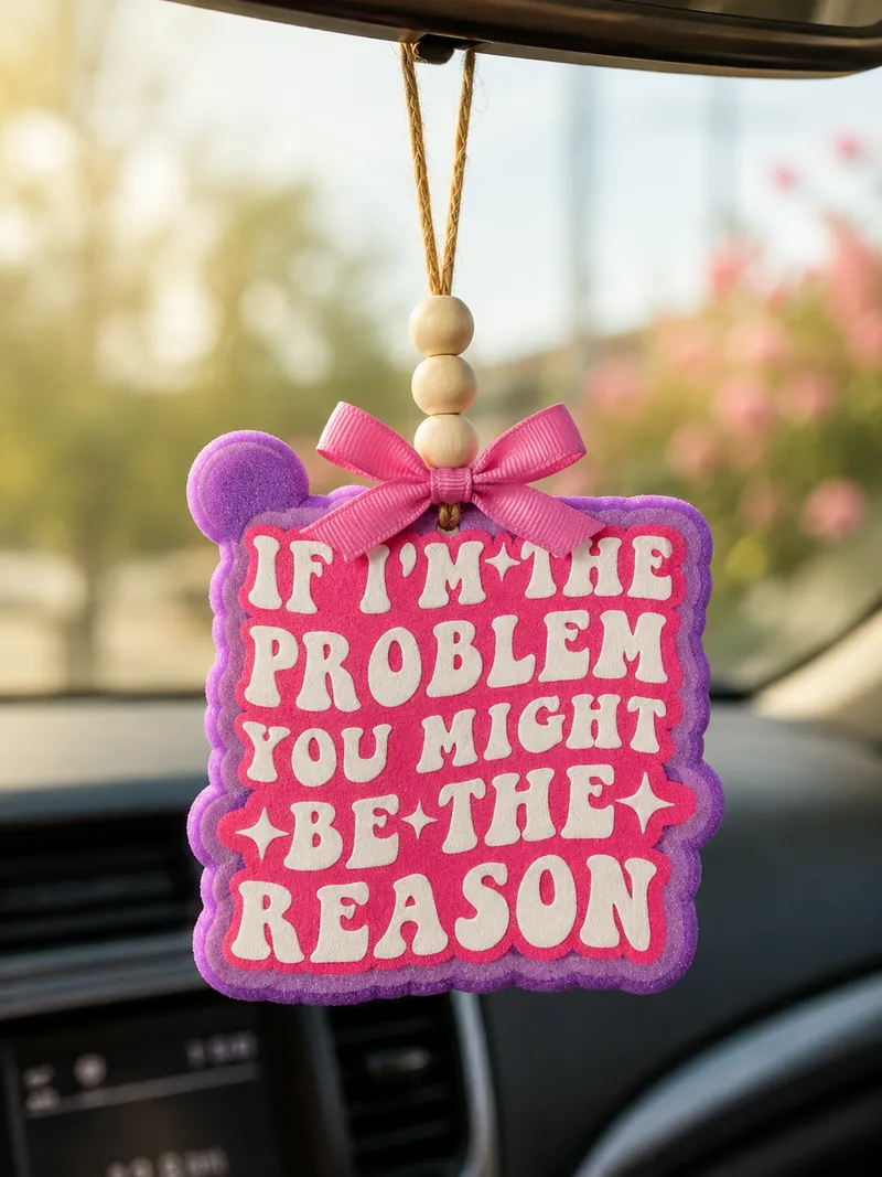 Handmade western-style aroma bead car freshie with bold 'The Problem' text design, hanging from a car rearview mirror as a funny novelty air freshener.